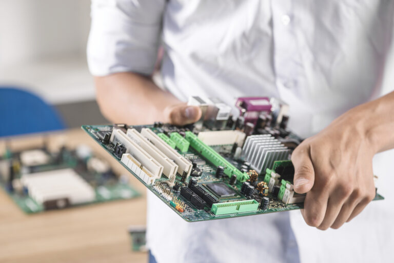 close-up-male-technician-holding-computer-motherboard